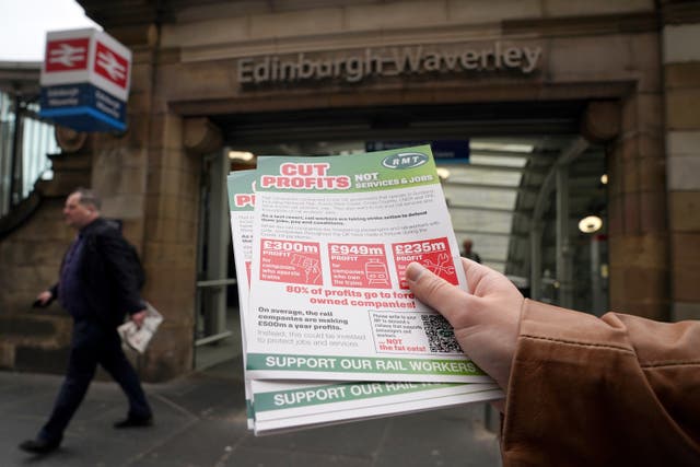 Members of the RMT picket at the entrance to Waverley Station in Edinburgh