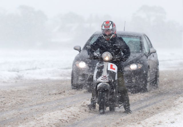 Vehicles make their way through snow near Kirby Cross in Essex