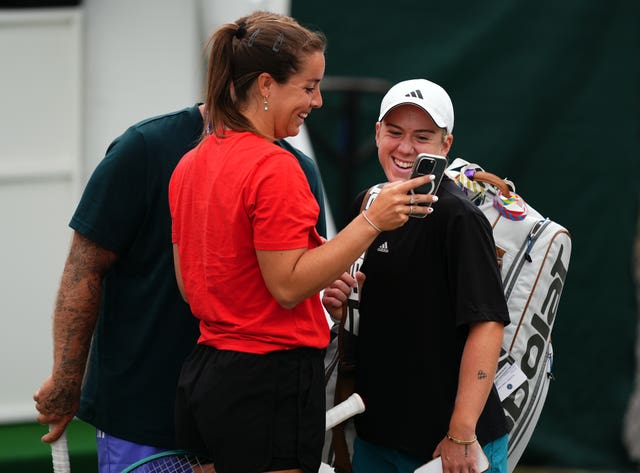 Sonay Kartal is shown something on a phone by Jodie Burrage