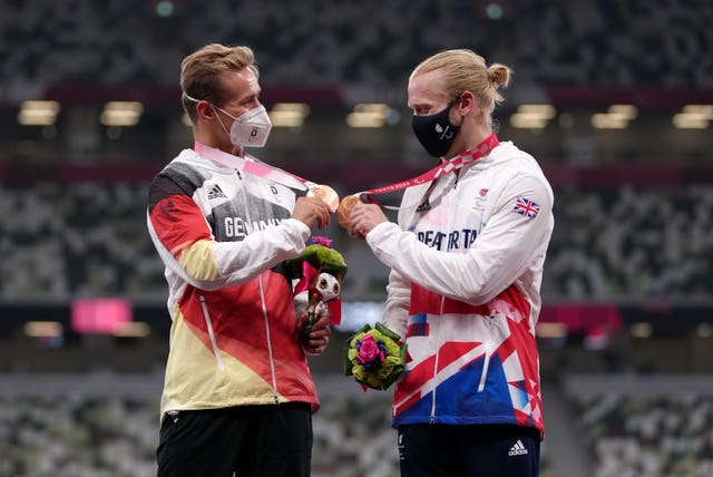 Great Britain’s Jonnie Peacock, right, and Germany’s Johannes Floors celebrate joint 100m bronze in Tokyo