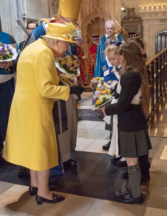 The Queen receives a nosegay during the Royal Maundy Service at St George’s Chapel in Windsor