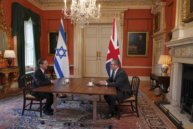 Isaac Herzog and Keir Starmer sit opposite each other at a table in 10 Downing Street