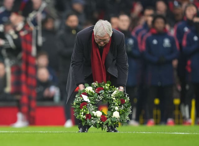 Sir Alex Ferguson observes a tribute to the late Denis Law ahead of the Premier League match at Old Trafford