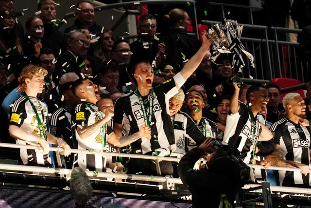 Dan Burn (centre) lifts the trophy after winning the Carabao Cup final