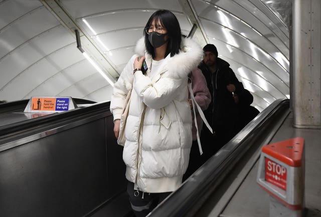 A women wearing a face mask at Leicester Square tube station (Kirsty O’Connor/PA)