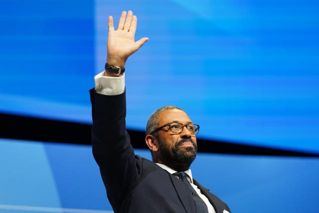 James Cleverly raising his hand