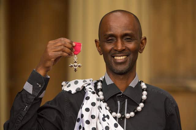 Eric Murangwa with his MBE medal, awarded by the Prince of Wales (PA)