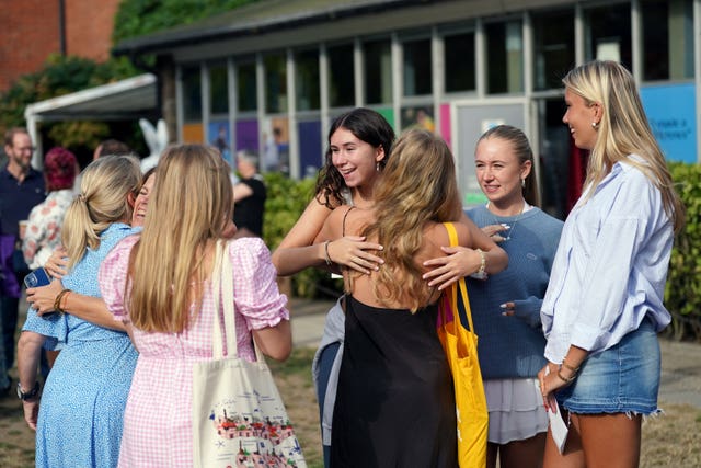 Jemima Miller, centre, hugging a person after reading their A-level results at Norwich School 