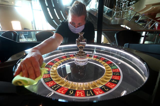 Worker cleans a roulette wheel