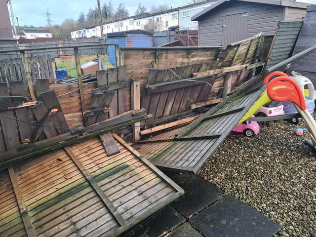 Damaged fence panels in the back garden of a house in west Belfast