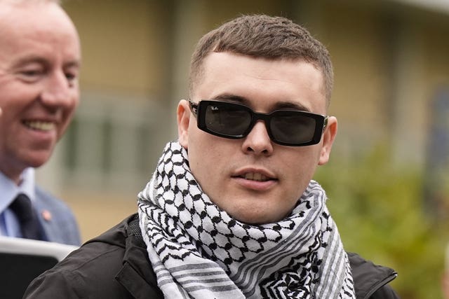 Liam Og O hAnnaidh wearing sunglasses and a keffiyeh