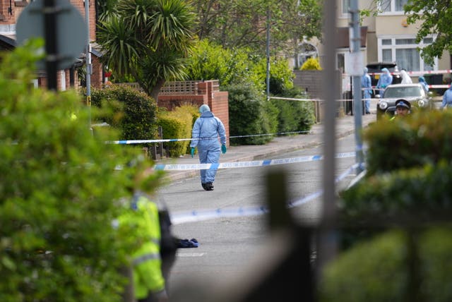 Forensic investigators in Laing Close in Hainault, north east London. 