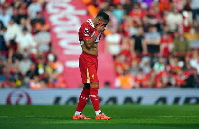 Liverpool forward Mohamed Salah puts his head in his shirt after missing a chance against Bournemouth