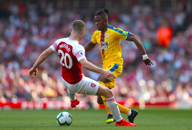 Shkodran Mustafi (left) and Crystal Palace's Wilfried Zaha battle for the ball