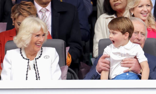 Then then-Duchess of Cornwall laughs with Prince Louis, who sits on his grandfather's lap, during the Platinum Jubilee celebrations 