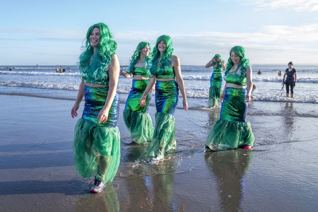 People take part in a Loony Dook New Year’s Day dip in the Firth of Forth at Kinghorn in Fife
