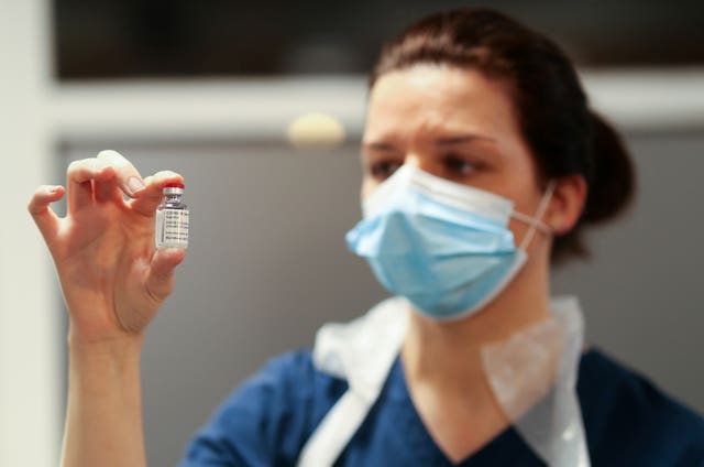 Medical worker holding vaccine vial