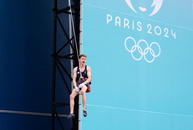 Great Britain’s Toby Roberts drops from the wall after his gold medal-winning climb