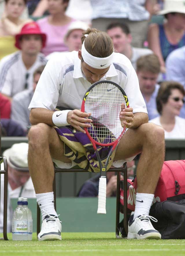 cA disconsolate Federer, the seventh seed, reflects on his defeat to 18-year-old Mario Ancic in the first round at Wimbledon in 2002