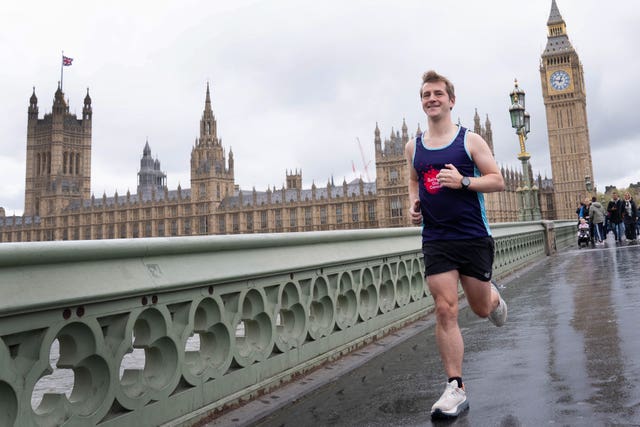 Josh Fenton-Glynn, Labour MP for Calder Valley, runs across Westminster Bridge in central London during training for the TCS London Marathon 2026