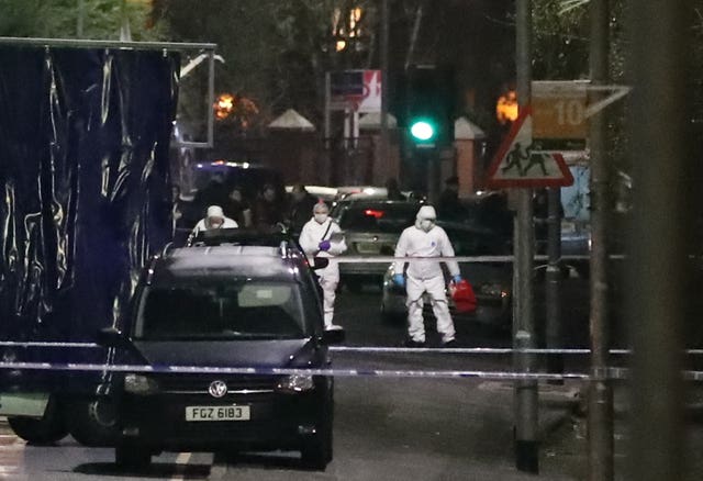 Forensic officers at the scene of a shooting near a school in west Belfast