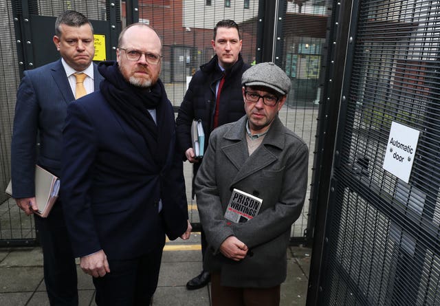 Journalists Barry McCaffrey (right) and Trevor Birney (second left) with their solicitors Niall Murphy (left) and John Finucane arrive at Musgrave police station in Belfast