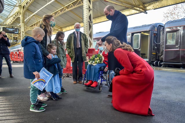 The Duke and Duchess of Cambridge take time to meet and chat with Jasmine Warner, 5, centre, who’s brother Otto, 8, left, has today come out of cancer treatment and was by chance hoping to meet the royal couple with his family, including sister Poppy, 10, right, and mum Georgie, as William and Kate arrive at Bath Spa train station, ahead of a visit to a care home in the city to pay tribute to the efforts of care home staff throughout the COVID-19 pandemic, on the final day of a three-day tour across the country