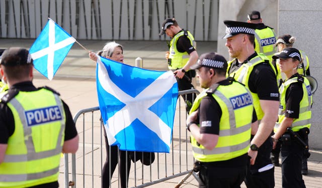 Police officers during an anti-immigration protest, organised by Unite the Clans Scotland, outside Holyrood in Edinburgh