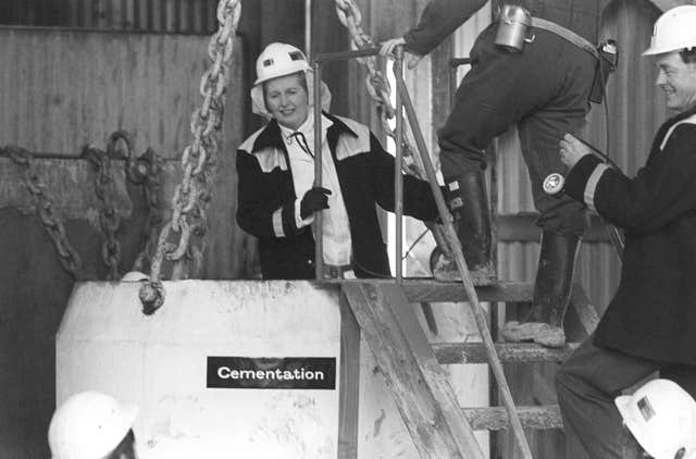 Margaret Thatcher, clad in white overalls, a miner’s helmet and donkey jacket, inside a five ton ‘kibble’, a large steel bucket suspended on chains before the descent down a mine shaft at the Wistow colliery in the Selby coalfield