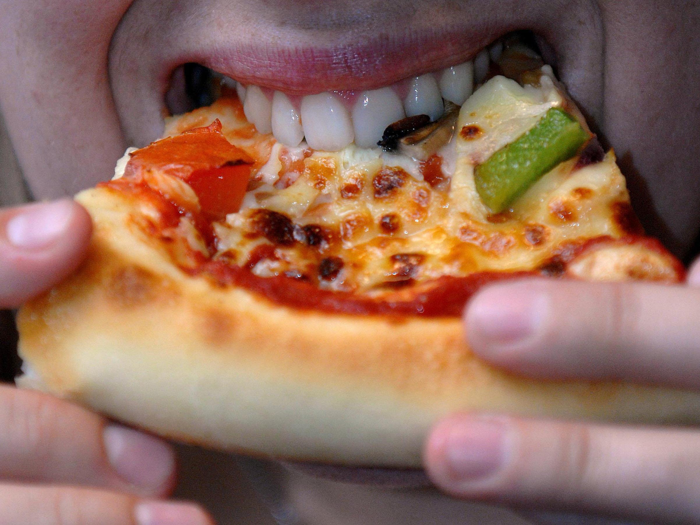 Person eating a pizza