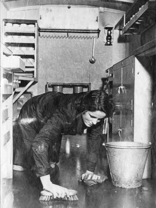 A volunteer cleans a floor of a canteen in London during the Second World War (Royal Voluntary Society/PA).