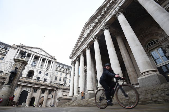 File photo dated 11/12/20 of a woman cycling past the Bank of England and the Royal Exchange in the City of London