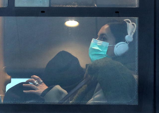 A woman wearing a face mask on a bus in London (Yui Mok/PA)