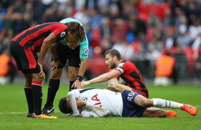 Tottenham Hotspurs' Dele Alli lies on the pitch