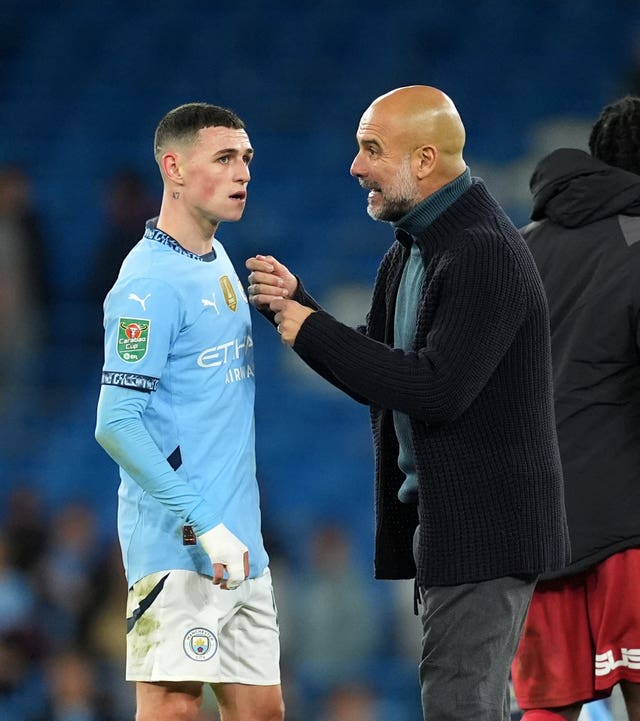 Pep Guardiola gives instructions to Phil Foden on the touchline