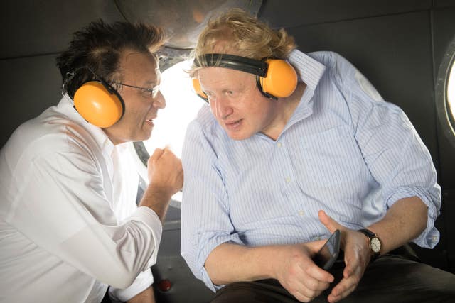 Boris Johnson on board a helicopter with his Peruvian counterpart Nestor Popolizio during a visit to the Amazon rainforest (Stefan Rousseau/PA)