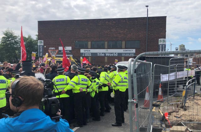 Anti-Tommy Robinson protesters attempt to block a campaign van arriving on Douglas Place in Bootle, Merseyside