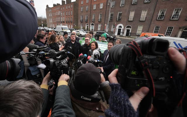 Sinn Fein leader Mary Lou McDonald speaking to the media with candidates Eoin O Broin (centre left), Matt Carthy (centre right) and supporters outside Government Buildings, Dublin