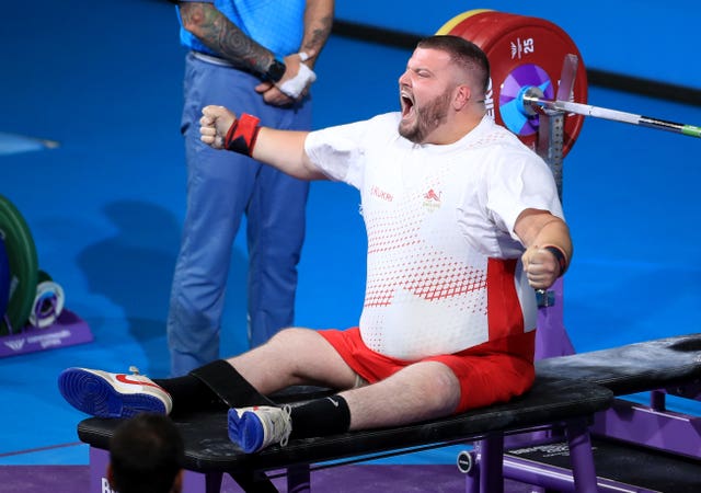 England's Liam McGarry celebrates after completing his final lift during the Para Powerlifting final at the 2022 Commonwealth Games in Birmingham