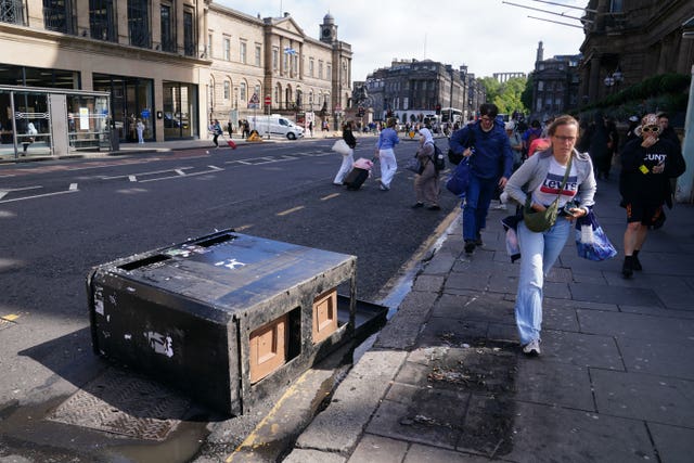 A bin bears the brunt of the strong winds on Princes Street in Edinburgh