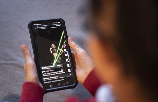 A young girl using social media app TikTok on a mobile phone, in Leeds. 