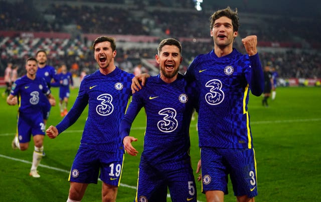 Chelsea’s Jorginho (centre) celebrates with team-mates Marcos Alonso (right) and Mason Mount after scoring their side’s second goal of the game from the penalty spot during the Carabao Cup quarter final match at the Brentford Community Stadium, London. Picture date: Wednesday December 22, 2021