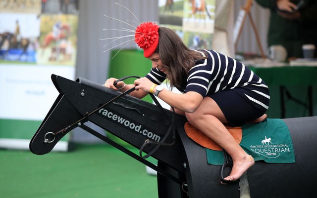 A female racegoer enters into the Grand National spirit during Ladies Day (Peter Byrne/PA)