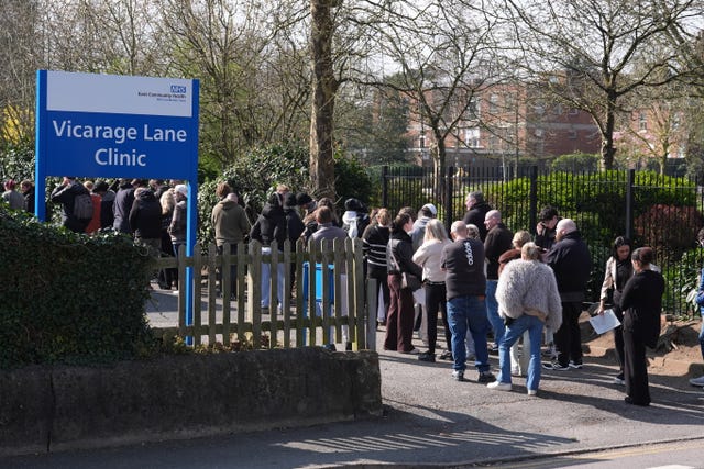 A large queue of students outside a building