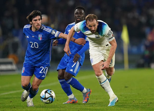 Italy's Sandro Tonali (left) and England’s Harry Kane battle for possession