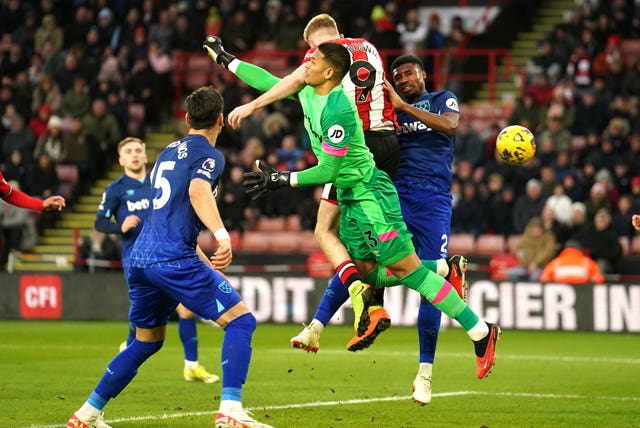 West Ham goalkeeper Alphonse Areola, centre, challenges Sheffield United’s Oli McBurnie and concedes a penalty