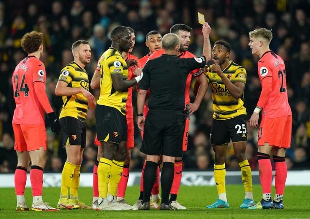 Emmanuel Dennis, second right, reacts to his red card