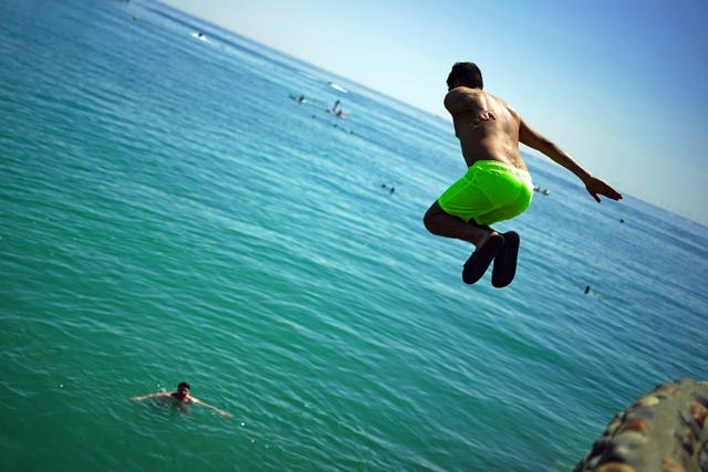 People enjoy the sunshine on Brighton beach