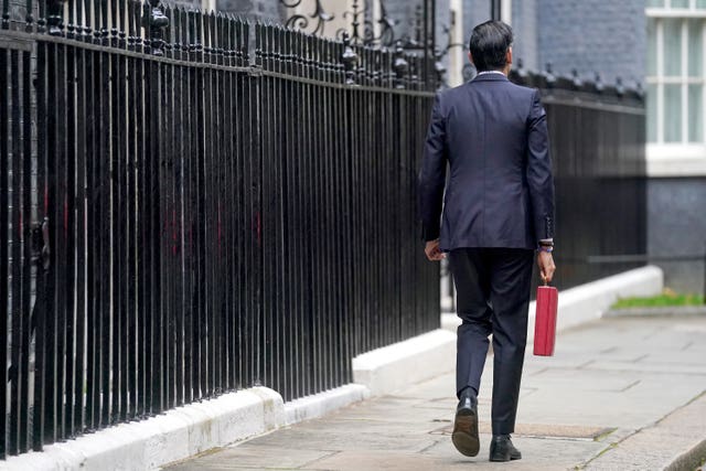 Chancellor of the Exchequer Rishi Sunak carries his ministerial Red Box as he leaves 11 Downing Street, London, before delivering his Budget (Victoria Jones/PA)