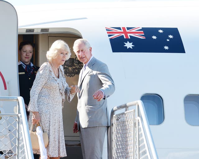 The then-Prince of Wales and the Duchess of Cornwall on the top steps of their Royal Australian Air Force jet in 2015